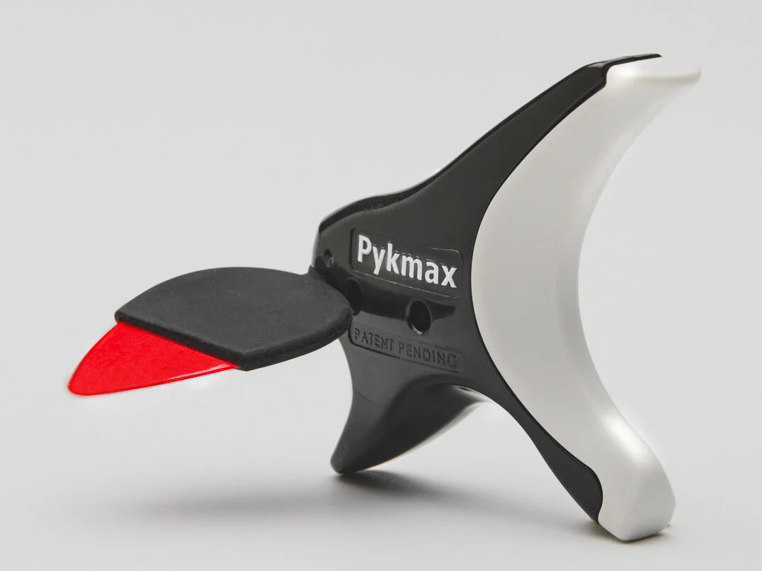 Pykmax Universal Picking Platform holding a guitar pick